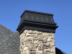 a brick chimney on the side of a house with a blue sky in the background