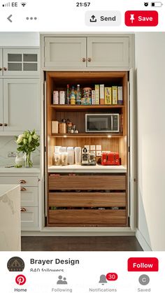 an open cabinet in the middle of a kitchen