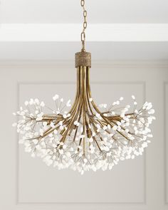 a chandelier with white flowers hanging from the ceiling