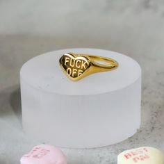 Express yourself with the F*** OFF Heart Ring! This playful accessory serves as a personal mantra, allowing you to subtly express yourself and your unique personality. Wear it with confidence and let it serve as a reminder to stay true to yourself. Material: Stainless Steel Plating: 18k real gold Ring is 100% nickel-free and cadmium-free Ring is tarnish resistant and hypoallergenic Trendy Heart Ring For Valentine's Day, Trendy Valentine's Day Gift Rings, Trendy Heart-shaped Ring For Gift, F Off, Personal Mantra, Stay True To Yourself, True To Yourself, Small Boutique, Jewelry Studio