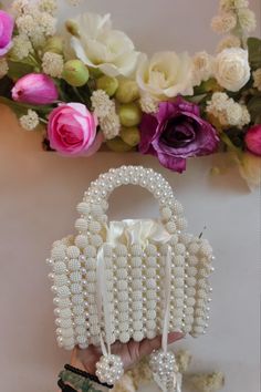 Introducing the Elegant White Beaded Handbag, a timeless chic accessory perfect for any occasion. This exquisite handbag features intricate beadwork, showcasing a stunning design that effortlessly combines elegance and sophistication. The pristine white beads glisten beautifully, making this bag a standout piece in your collection. Ideal for both day and evening wear, the Elegant White Beaded Handbag is spacious enough to hold your essentials while maintaining a sleek and refined look. Whether y White Beaded Shoulder Bag For Gift, Pearl White Beaded Wedding Bags, Elegant Pearl Beaded Shoulder Bag, Elegant Beaded Pearl Shoulder Bag, Elegant Pearl Beaded Bag, Timeless Chic, Beaded Bag, Beaded Handbag, Beaded Bags