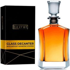 a bottle of glass decanter next to a box