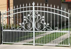 an iron gate is shown in front of a house