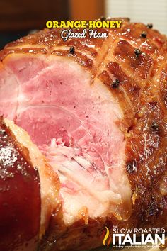 an orange honey glazed ham is shown on a plate with the words, orange honey baked ham