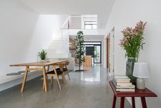 a table and chairs in a room with white walls