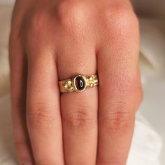 A beautiful organic 18k solid yellow gold ring with hammered surface, about 4.5- 5mm wide and a deep red garnet center stone.  With 3 small golden balls on either side.  This ring is made with sacred geometry and divine numbers.  A very special and unique ring for protection  18k yellow gold  4.5-5mm wide  Weight: About 6g Thickness: about 1mm + a garnet stone - 7x5 Please send a message for a custom order - can be made with any center stone and in any color / karat of gold.  ◈ ENGRAVING is optional for $7 per letter/number/character. Please pay using the engraving order form at this link: https://www.etsy.com/il-en/listing/1067854382/personalisation-engravings?ref=shop_home_active_1&frs=1&crt=1 Please note that engraved jewellery cannot be exchanged or returned ◈ SHIPPING is insured expre Elegant Hand Forged Yellow Gold Ruby Ring, Gold Garnet Signet Ring For Anniversary, Gold Garnet Rings With Cabochon, Yellow Gold Garnet Signet Ring With Gemstone, Divine Numbers, Hammered Gold Ring, Antique Style Rings, Beautiful Wedding Bands, Body Sweat