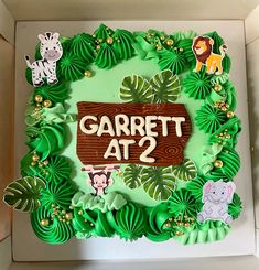 there is a cake in the box that says garrett at 2 on it