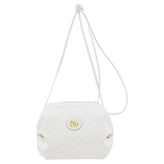 White Gucci supreme coated canvas shoulder bag featuring an all over logo pattern in tan. Tonal grained leather trim throughout. Logo hardware at shoulder strap. Logo plaque at face. Hoop hardware and ruched detailing at sides. Zip closure. Three card slots and detachable lanyard clasp on curb chain at interior. Navy blue and pink floral-patterned textile lining. Antiqued gold-tone hardware. Excellent vintage condition. Gucci by Alessandro Michele. Made in Italy. Sold with original dust bag. 11" White Sling Bag, Navy Blue And Pink, Gucci Crossbody Bag, Gucci Crossbody, Gucci Outfits, Gucci Tote, Designer Outfits, Pink Floral Pattern, Ostrich Leather