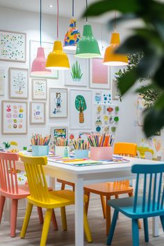 colorful children's chairs sit around a white table in front of pictures on the wall