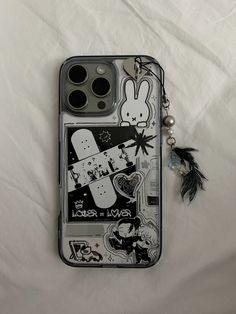 a cell phone case with an image of a rabbit on it and a keychain hanging from the back