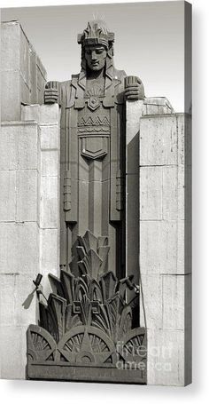 a black and white photo of a statue in front of a building