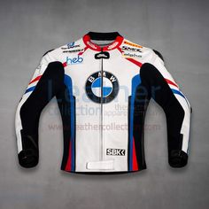 a white and blue motorcycle jacket sitting on top of a table