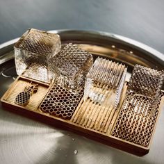 several pieces of glass sitting on top of a metal tray