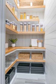 an organized pantry with lots of shelves and bins