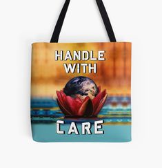 a tote bag with the words handle with care on it and a globe in the middle