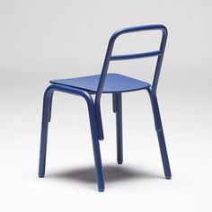 a blue chair sitting on top of a white floor