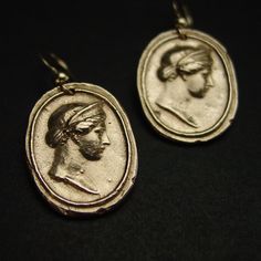 Handmade intaglio reproduction showing the birthing goddess Hera. Hera was a powerful goddess, the wife and sister of Zeus. She was worshiped as the Queen of Heaven as well as the Goddess of Marriage, Women and Birth. Roman equivalent Juno. - Handmade cameos - Solid yellow bronze also called jeweler gold bronze cameos. - 14k gold filled ear wire. - Gold filled has 100 times more gold than plated so does not rub or peel off. - Nickel free. - Reproduction of a 17th c. Victorian cameo. - Signed in Gold Hand Cast Dangle Earrings, Antique Oval Handmade Earrings, Handmade Oval Antique Earrings, Symbolic Bronze Drop Earrings, Brass Medallion Earrings For Pierced Ears, Brass Medallion Earrings As A Gift, Yellow Gold Medallion Brass Earrings, Symbolic Pierced Hoop Earrings, Elegant Hand Cast Brass Earrings