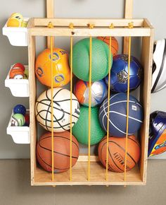 a wooden crate filled with lots of different colored balls