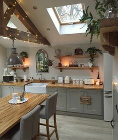 a kitchen filled with lots of counter space next to a wooden dining table and chairs