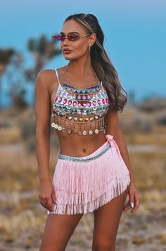 Liah rhinestone festival outfit The festival outfit that you need for the next party, designed for women who loves to make a statement but want to make it simple. Perfect for summer festivals, rave parties, or birthday bashes. This amazing outfit are made with a two piece set with a beautiful rhinestone harness top with multicolour stones adorn on a gold chain. The pink skirt is a "tie on the side wrap skirt" made out of fringes that moves beautifully when dancing around at festivals. The skirt Rhinestone Harness, Tulum Outfits, Festival Skirt, Festival Rave Outfit, Beach Festival, Festival Skirts, Summer Festivals, Chain Top, Fringe Skirt