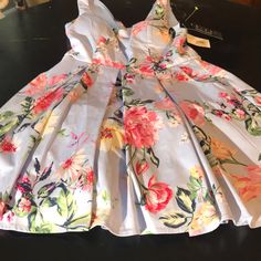 This Is A Beautiful Nwt Dress In Size 9. Top Is Padded. Layered Full Bottom Skirt. ( See Pic ) Length 32.5 In. Bust 14.5 In Waist 14.5 In. Super Flattering. 97 Cotton/ 3 Spandex. Lining 100 Polyester. Fast Shipping Spring Pleated Mini Dress For Garden Party, Dressy Fitted Floral Print Mini Dress, Spring Pleated Dress For Garden Party, Sleeveless Floral Dress For Summer Formal, Fitted Pleated Floral Dress For Garden Party, Dressy Floral Print Mini Dress For Spring, Spring Floral Print Mini Dress, Formal Sleeveless Floral Dress For Summer, Fitted Blue Floral Dress For Garden Party