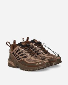 a pair of brown hiking shoes on a white background