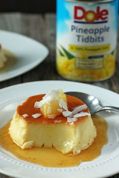 a piece of cake on a white plate with caramel sauce and pineapple topping