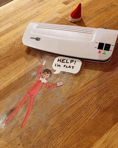 an elf laying on the floor next to a heater with help in flat stickers