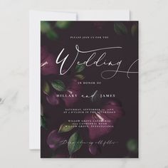 a wedding card with purple flowers and greenery on the front, in white ink