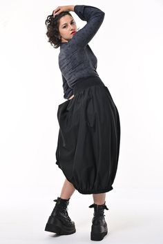 Tale: transcend the room in your Ram Parachute Skirt. This full but streamlined silhouette with gathered hem is contemporary and sleek. The large pockets are a must for all your essentials, big enough for your phone. This pull-on skirt is made from cotton poplin with a rib waistband that is comfortable and creates a cinched waist. Our model is 5ft 7" and wears an S with our Kenza Wrap. The skirt is approximately 90cm from the top of the waistband to the hem. Please see our size guide and if you are between two sizes then go to the smaller size. 97% BCI Cotton 3% Elastane Cotton Poplin, Waistband 95% Cotton 5% Elastane Made in Britain 97% BCI Cotton 3% Elastane Cotton Poplin, Waistband 95% Cotton 5% Elastane Wash at 30* Warm Tumble Dry Warm Iron Do Not Bleach Do Not Dry Clean Small Frocks, Parachute Skirt, Knit Loungewear, Stocking Fillers For Her, Holiday Party Outfit, Independent Designers Fashion, Wrap Top, Cinched Waist, Black Media