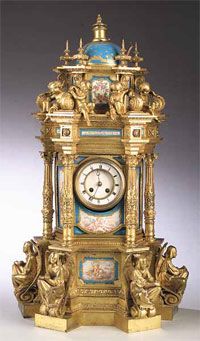 an ornate gold clock with blue and white decorations