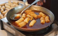 a pan filled with food sitting on top of a stove