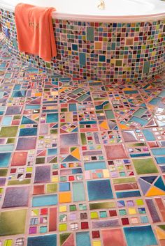 a bath tub sitting on top of a tiled floor