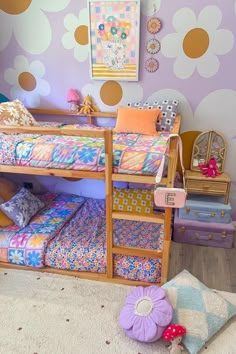 a child's bedroom with two bunk beds and colorful wallpaper on the walls