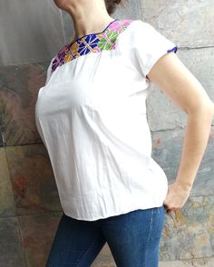 Beautiful blouse made by hand in Chiapas, Mexico creating fashion and art. This is a medium to large blouse white with beautiful colorful and short sleeve. Very comfortable, Goes great with jeans, leggings, skirt, shorts... Each piece is unique and handmade with dedication and taking care of every detail achieving the best quality in our products, which is why it makes it beautiful and unique each of the embroidered flowers. Available color black Size MEDIUM/LARGE 1 Shoulder: 17-18 inches 2 Bust Embroidered Short Sleeve Tops With Stretch, Embroidered Short Sleeve Stretch Tops, Short Sleeve Embroidered Stretch Tops, Embroidered Stretch Short Sleeve Tops, White Embroidered Neckline Top For Summer, White Floral Embroidered T-shirt, White Summer Blouse With Embroidered Neckline, Summer White Blouse With Embroidered Neckline, White Floral Embroidery Short Sleeve T-shirt