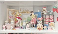 there are many figurines on the shelf