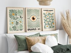 three posters on the wall above a bed in a room with green and white decor