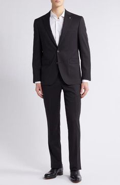 Crisp and classic, this suit tailored from black wool features traditional detailing and makes a versatile, polished addition to any formal wardrobe. Jacket has notched lapels; four-button cuffs; chest pocket; flap pockets; side vents Trousers have zip fly with button-tab closure; slant pockets; back button-welt pockets Jacket is lined; trousers are lined to the knee Unhemmed 100% wool Dry clean Made in Canada Tailored Three-piece Suit With Pressed Crease For Business Meetings, Tailored Three-piece Suit For Business Meetings, Classic Tuxedo With Hidden Button For Work, Classic Tuxedo With Hidden Button Closure For Work, Classic Slim Fit Double Breasted Suit For Formal Occasions, Slim Fit Timeless Tuxedo For Business, Tailored Classic Business Suits, Business Suit With Concealed Placket In Suiting Fabric, Fitted Suits For Business Meetings