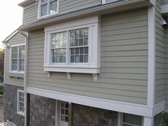 the side of a house with windows and siding