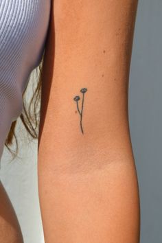 a woman with a tattoo on her arm and the back of her body is shown