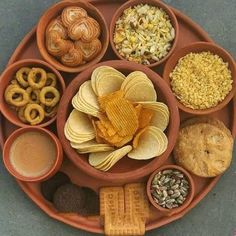 a plate filled with different types of food on top of a table next to cookies and crackers