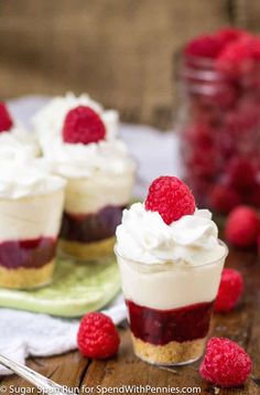 raspberry cheesecake cups with whipped cream and fresh raspberries on the side