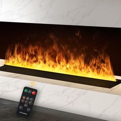 a remote control sitting in front of a fireplace that is glowing orange and yellow fire