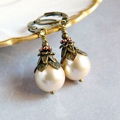 Victorian Pearl Earrings - Ivory Cream Bridal Earrings - Vintage White Pearl Drops - Rustic Boho Wedding .. .. .. These ornate Victorian Pearl Earrings are adorned in layers of graceful vintage style antique gold bead caps, and small round beads. The Czech glass pearls are designed with a rustic boho flair. Personalized your Pearl Earrings with your choice of pearl colors. Select Victorian Cream or White Pearls from the drop down menu. Pearl Earrings always make a thoughtful gift for her. . . . Cream Pearl Earrings For Formal Occasions, Antique White Pearl Jewelry, Antique White Drop Earrings, Vintage Round Pearl Drop Jewelry, Vintage Pearl White Wedding Jewelry, Ornate White Pearl Drop Earrings, Delicate Cream Pearl Drop Jewelry, Delicate Cream Jewelry With Pearl Drop, Cream Pearl Drop Jewelry For Anniversary