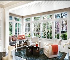 a living room filled with furniture and lots of windows