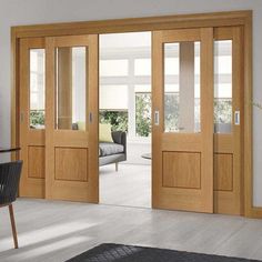 a living room filled with furniture and wooden doors