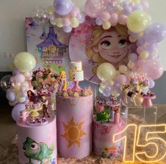 a table topped with lots of balloons and decorations