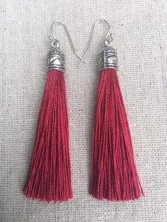 Chic dark red tassel earrings!  They would add a pop of color to any outfit for any occasion.  Dress them up or down.  They are timeless and versatile.  They are lightweight, fun and unique!The tassels measure 2 1/8” long by 1/4” wide.  They hang from simple silver ear wire hooks.  Overall drop length is about 2 1/4”.  Metal is allergy free plated silver.These are my latest creation!  I have them available in many colors!  Find them all under the category tassel earrings in my shop.Thanks for st Maroon Earrings, Dark Red Earrings, Burgundy Earrings, Modern Silver Earrings, Modern Hoop Earrings, Tiger Earrings, Boho Hoop Earrings, Simple Hoop Earrings, Statement Hoop Earrings