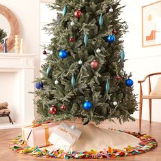 a decorated christmas tree in a living room with presents on the floor next to it