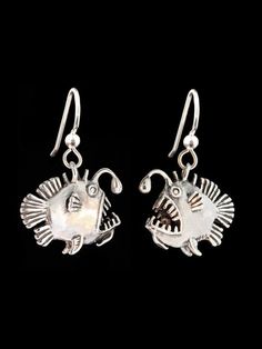 These whimsical Angler Fish Earrings are cast in sterling silver and are completely solid and three dimensional.  Each earring charm is 1" (25 mm) long, detailed both front and back and can stand freely on it's lower fins. May this ugly but personable fish amuse and delight you! Beauty is in the eyes of the beholder.This item usually ships the same or next business dayAll Marty Magic Jewelry is packaged in a beautiful  box, embossed with the gold foil Marty Magic dragon logo. Perfect for any occ Silver Fish-shaped Sterling Silver Earrings, Silver Sterling Fish-shaped Earrings, Handmade Silver Fish-shaped Earrings, Silver Fish-shaped Earrings With Ear Wire, Silver Fish-shaped Earrings With Fish Hooks, Nickel-free Silver Fish-shaped Earrings, Handmade Sterling Silver Fish-shaped Jewelry, Handmade Sterling Silver Fish Jewelry, Angler Fish Art